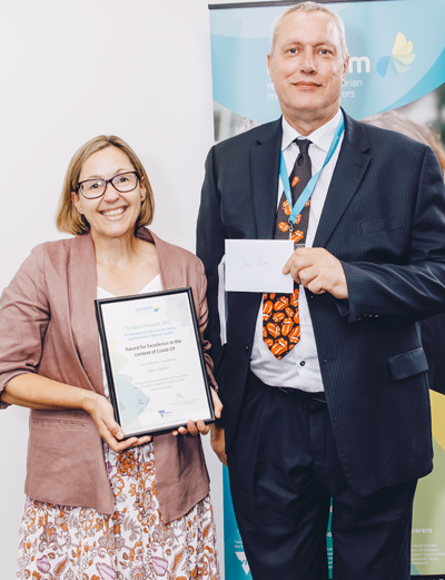 Julia Quin is presented the Award for Excellence in the context of COVID-19 by Tandem Board member, Graeme Doidge.